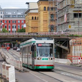 Straßenbahn fährt unterhalb der Eisenbahnbrücke in der Hallischen Straße.